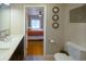 View of a bedroom with hardwood floors from the bathroom with a double vanity at 4825 S Delaware St, Englewood, CO 80110