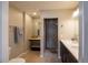 Bathroom featuring an enclosed tile shower, single vanity, and shelf space at 4825 S Delaware St, Englewood, CO 80110