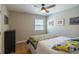 This comfy bedroom features a ceiling fan and a colorful quilt that adds charm to the room at 4825 S Delaware St, Englewood, CO 80110