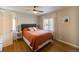 Cozy bedroom features a queen-sized bed, ceiling fan, and natural light, perfect for relaxation and rest at 4825 S Delaware St, Englewood, CO 80110