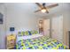 Bedroom featuring a ceiling fan, yellow nightstand, and quilted bedding at 4825 S Delaware St, Englewood, CO 80110