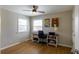 Bedroom featuring a ceiling fan and desk with storage space under two windows at 4825 S Delaware St, Englewood, CO 80110