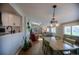 Inviting dining area with views to the kitchen and living room, featuring a stylish chandelier and bright skylight at 4825 S Delaware St, Englewood, CO 80110