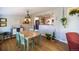 Charming dining area with views into the modern kitchen, perfect for Gathering meals and entertaining guests at 4825 S Delaware St, Englewood, CO 80110