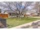 Attractive home with a well-maintained front yard, mature trees, and welcoming exterior at 4825 S Delaware St, Englewood, CO 80110