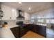 Modern kitchen features sleek black appliances, two-tone cabinets, quartz countertops, and an efficient layout at 4825 S Delaware St, Englewood, CO 80110
