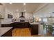 Beautiful kitchen boasts two-toned cabinets, modern appliances, quartz countertops, and an open layout to the living spaces at 4825 S Delaware St, Englewood, CO 80110