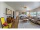 Spacious living room with hardwood floors, a decorative rug, and a view of a hallway and doorway at 4825 S Delaware St, Englewood, CO 80110