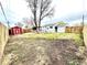Spacious backyard with a shed, wood fence, grassy area, and a covered patio, offering ample outdoor space at 7901 Newport St, Commerce City, CO 80022