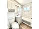 Modern bathroom features white marbled tiled walls, tub-shower combo, and light gray vanity at 7901 Newport St, Commerce City, CO 80022