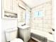 Stylish bathroom with a shower-tub combination and vanity, complemented by classic white tiling at 7901 Newport St, Commerce City, CO 80022