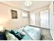 Bedroom features comfortable bedding, ample natural light, and stylish decor at 7901 Newport St, Commerce City, CO 80022