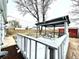 Outdoor deck features painted railing, a covered pergola, and outdoor seating with a view of the fenced backyard at 7901 Newport St, Commerce City, CO 80022