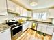 Charming kitchen featuring granite countertops, stainless steel appliances and white cabinetry at 7901 Newport St, Commerce City, CO 80022