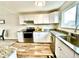 Bright kitchen featuring white cabinets, stainless steel appliances, and granite countertops at 7901 Newport St, Commerce City, CO 80022