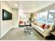 Comfortable living room with plush carpeting, large window, and stylish decor at 7901 Newport St, Commerce City, CO 80022