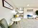 Bright living area showcases dining space and kitchen with natural light and plush carpet at 7901 Newport St, Commerce City, CO 80022