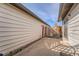 Backyard patio with siding, wood fence, air conditioning unit, and a red door at 16036 E Ithaca Pl # E, Aurora, CO 80013