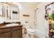 This bathroom offers a sink with wood cabinets, a shower and tub combo, and a large mirror at 16036 E Ithaca Pl # E, Aurora, CO 80013