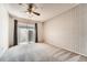 This bedroom offers neutral walls and carpeting, a ceiling fan, and sliding glass doors to the exterior at 16036 E Ithaca Pl # E, Aurora, CO 80013