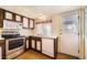 This kitchen offers white appliances, tile floor, white counters, light and dark cabinets, and a white door at 16036 E Ithaca Pl # E, Aurora, CO 80013