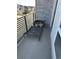 Cozy balcony featuring gray flooring, metal railings, and exterior stone accents at 11400 W Grand Ave, Littleton, CO 80127