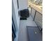 A spacious balcony with metal railings, a dog potty area, and space for outdoor seating at 11400 W Grand Ave, Littleton, CO 80127