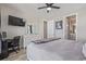 Bright bedroom with a desk, TV and a view of the bathroom and closet at 11400 W Grand Ave, Littleton, CO 80127