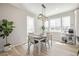 Charming dining area with modern light fixture, bright windows, and adjacent storage at 11400 W Grand Ave, Littleton, CO 80127