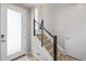 Bright entryway with modern staircase and a stylish frosted glass front door at 11400 W Grand Ave, Littleton, CO 80127
