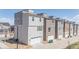 View of the exteriors of these modern, multi-story homes and their individual attached garages at 11400 W Grand Ave, Littleton, CO 80127