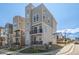 Modern three-story home featuring a stone facade and a small front yard at 11400 W Grand Ave, Littleton, CO 80127