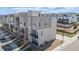 View of a modern multi-story townhome and its exterior features at 11400 W Grand Ave, Littleton, CO 80127