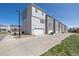 View of the exteriors of these modern, multi-story homes and their individual attached garages at 11400 W Grand Ave, Littleton, CO 80127