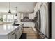 Bright kitchen with white cabinetry, stainless steel refrigerator and a large kitchen island at 11400 W Grand Ave, Littleton, CO 80127