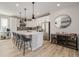 Modern kitchen featuring white cabinetry, stainless steel appliances, and a large central island at 11400 W Grand Ave, Littleton, CO 80127