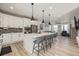 Stylish kitchen with white cabinets, a large center island, and stainless steel appliances at 11400 W Grand Ave, Littleton, CO 80127