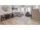 Inviting living room with ample natural light, plush seating, and a staircase to the upper level at 11400 W Grand Ave, Littleton, CO 80127