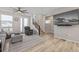 Cozy living area featuring a comfortable recliner, modern TV, and a staircase to the upper level at 11400 W Grand Ave, Littleton, CO 80127