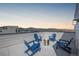 Rooftop deck featuring a fire pit and blue Adirondack chairs with mountain views at 11400 W Grand Ave, Littleton, CO 80127