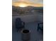 Enjoy mountain views from this rooftop patio with Adirondack chairs and a modern fire pit at sunset at 11400 W Grand Ave, Littleton, CO 80127