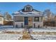 Charming bungalow with a newly renovated exterior and snowy front yard at 2222 Fenton St, Edgewater, CO 80214