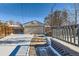 Attached garage and deck with snow covered driveway at 2222 Fenton St, Edgewater, CO 80214