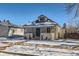 Charming bungalow with a blue door and snowy front yard at 2222 Fenton St, Edgewater, CO 80214