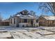 Front view of charming bungalow with snowy yard at 2222 Fenton St, Edgewater, CO 80214