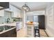 Modern kitchen with white cabinets, an island, and subway tile at 2222 Fenton St, Edgewater, CO 80214