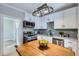 Stylish kitchen with white cabinets, wood countertops and a pot rack at 2222 Fenton St, Edgewater, CO 80214