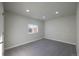 Well-lit bedroom with grey carpet and a window offering natural light at 5341 Granby St, Denver, CO 80239