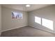 Well-lit bedroom with grey carpet and large window at 5341 Granby St, Denver, CO 80239