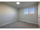 Bright, carpeted bedroom with a window providing natural light at 5341 Granby St, Denver, CO 80239